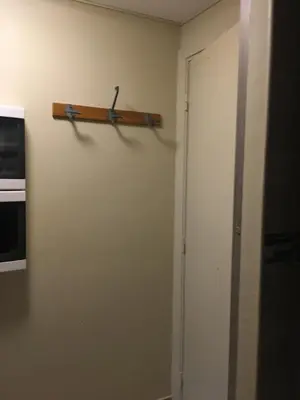 a pair of scissors hanging on a wall next to a door at Studette de Cannes in Cannes