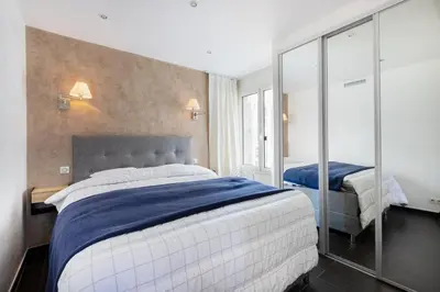 a bedroom with two beds and a mirror at CROISETTE - 2 Pièces rénové avec vue Mer in Cannes