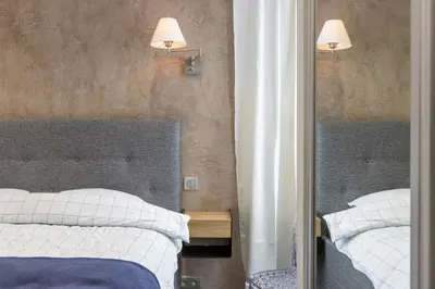 a bedroom with two beds and a mirror at CROISETTE - 2 Pièces rénové avec vue Mer in Cannes