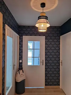 a hallway with a window and a chandelier at HENRI CAMILLE RE - Passy 2 -Beautiful one bedroom swimming pool and parking in Cannes