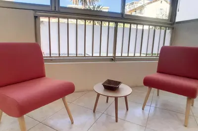 two chairs and a table in front of a window at HENRI CAMILLE REAL ESTATE - Latour - Studio 150m Martinez in Cannes