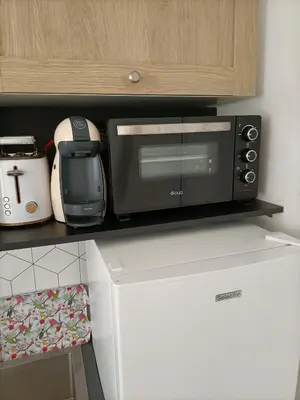 a microwave sitting on top of a kitchen counter at Le St Nicolas in Cannes