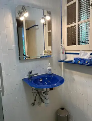 a bathroom with a blue sink and a mirror at Charming Villa-Appartement With A View On The Sea Of 95 M2 in Cannes