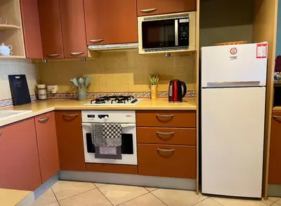 a kitchen with a white refrigerator and a stove at Charming Villa-Appartement With A View On The Sea Of 95 M2 in Cannes