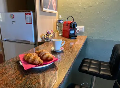 a table with a plate of croissants and a cup of coffee at Charming Villa-Appartement With A View On The Sea Of 95 M2 in Cannes