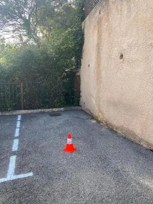 a orange cone sitting in the middle of a parking lot at Charming Villa-Appartement With A View On The Sea Of 95 M2 in Cannes