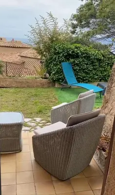 a group of chairs and a blue chair on a patio at Charming Villa-Appartement With A View On The Sea Of 95 M2 in Cannes