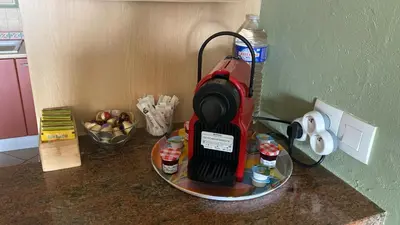 a kitchen counter with a red blender on a table at Charming Villa-Appartement With A View On The Sea Of 95 M2 in Cannes