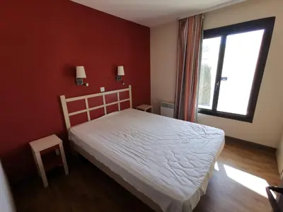 a bedroom with a white bed and a window at Cannes Villa Francia appartement 7 personnes climatisé in Cannes