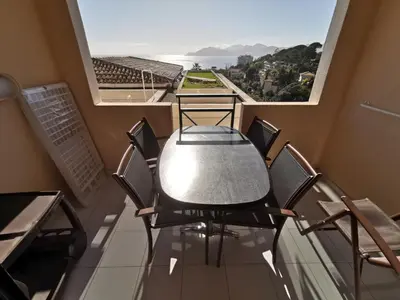 a table and chairs on a balcony with a view at Cannes Villa Francia appartement 7 personnes climatisé in Cannes