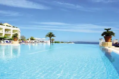 a large swimming pool with blue water and palm trees at Cannes Villa Francia appartement 7 personnes climatisé in Cannes