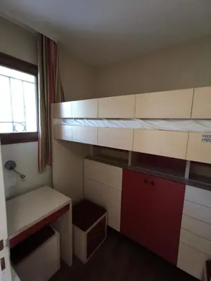 an empty room with a bed and a desk at Cannes Villa Francia appartement 7 personnes climatisé in Cannes