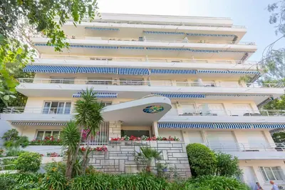 a large white building with plants in front of it at Florida 35m studio with sea views close to the Croisette in Cannes