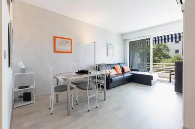 a living room with a table and a couch at Florida 35m studio with sea views close to the Croisette in Cannes