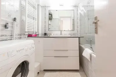 a white bathroom with a washing machine and a sink at Florida 35m studio with sea views close to the Croisette in Cannes