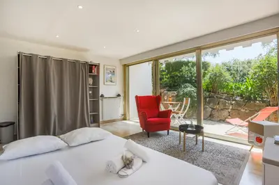 a bedroom with a bed and a red chair at Studio A/C La Californie with patio by Olidesi in Cannes