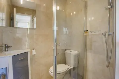 a bathroom with a shower and a toilet and a sink at Studio A/C La Californie with patio by Olidesi in Cannes