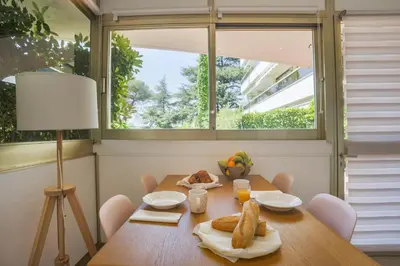 a dining room with a table and a window at Studio A/C La Californie with patio by Olidesi in Cannes