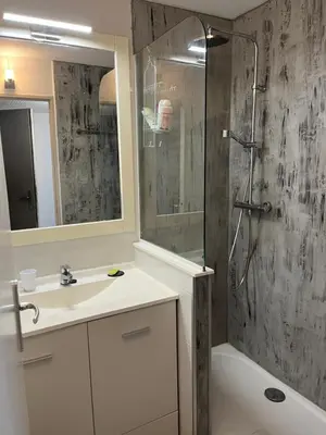 a bathroom with a shower and a sink and a mirror at Fantastic located studio in Cannes