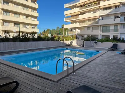 a swimming pool in front of a building at Fantastic located studio in Cannes