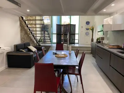 a kitchen and dining room with a table and chairs at Sunflower apartments in Cannes
