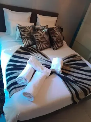 two towels on top of a bed at Le Cocon des Artistes - Coeur de Cannes - Spacieux - Terrasse - Clim in Cannes