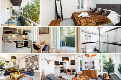 a living room with a black leather couch and a red sign at Le Cocon des Artistes - Coeur de Cannes - Spacieux - Terrasse - Clim in Cannes