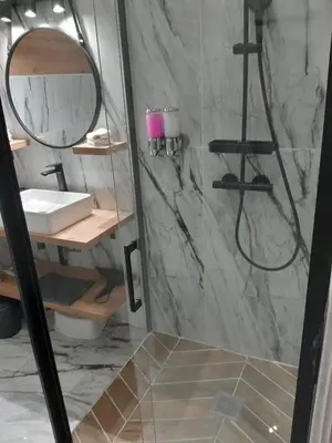 a bathroom with a sink and a shower with a mirror at Le Cocon des Artistes - Coeur de Cannes - Spacieux - Terrasse - Clim in Cannes
