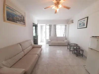 a living room with a couch and a ceiling fan at Palais des Iles in Cannes