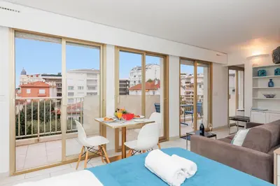 a room with a bed and a couch and a table at Bleu Croisette YourHostHelper in Cannes
