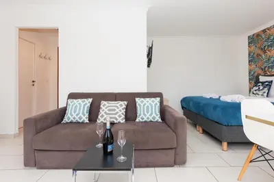 a living room with a couch and a bed at Bleu Croisette YourHostHelper in Cannes