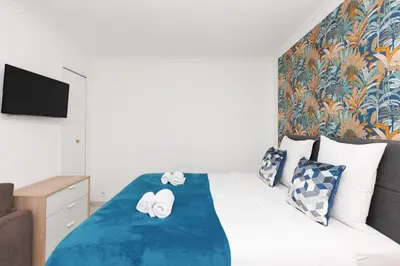 a bedroom with a bed with a blue blanket at Bleu Croisette YourHostHelper in Cannes