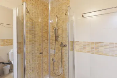 a bathroom with a shower with a glass door at Bleu Croisette YourHostHelper in Cannes