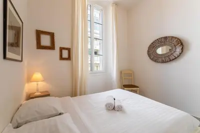 a bedroom with a white bed with two shoes on it at Freres PradignacLAT1101 in Cannes