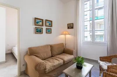 a living room with a couch and a window at Freres PradignacLAT1101 in Cannes