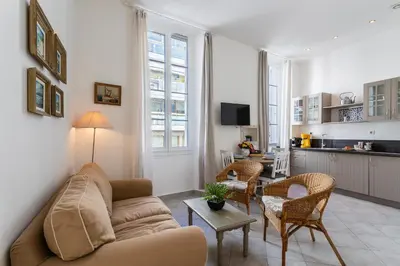 a living room with a couch and a table at Freres PradignacLAT1101 in Cannes