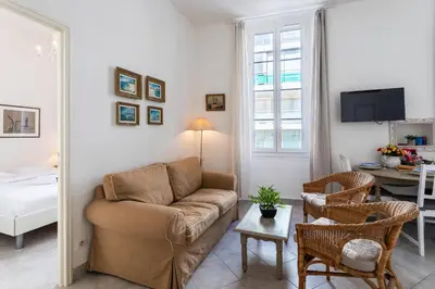 a living room with a couch and a table at Freres PradignacLAT1101 in Cannes