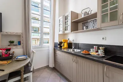 a kitchen with white cabinets and a counter top at Freres PradignacLAT1101 in Cannes
