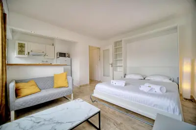 a living room with a bed and a couch at IMMOGROOM - Cosy - California - Close to everything in Cannes