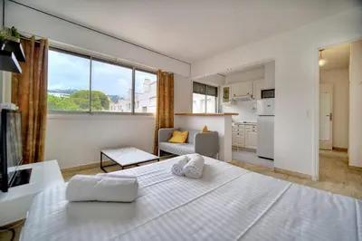 a bedroom with a white bed and a large window at IMMOGROOM - Cosy - California - Close to everything in Cannes
