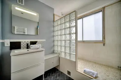 a bathroom with a sink and a mirror at IMMOGROOM - Cosy - California - Close to everything in Cannes
