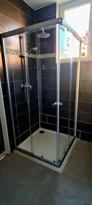 a shower with a glass door in a bathroom at IMMOGROOM - Renovated - Terrace - Air conditioning - Quiet - Carnot in Cannes