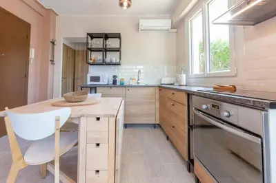 a kitchen with a wooden table and a counter at Secret Garden ideal for Congrès and Holidays LIVE IN LE FLORENCE in Cannes