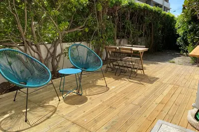 two chairs and a table on a wooden deck at Secret Garden ideal for Congrès and Holidays LIVE IN LE FLORENCE in Cannes
