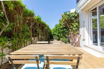 a wooden pathway with benches on a deck at Secret Garden ideal for Congrès and Holidays LIVE IN LE FLORENCE in Cannes