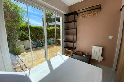 a bedroom with a bed and a large window at Secret Garden ideal for Congrès and Holidays LIVE IN LE FLORENCE in Cannes