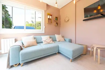 a living room with a blue couch and a window at Secret Garden ideal for Congrès and Holidays LIVE IN LE FLORENCE in Cannes
