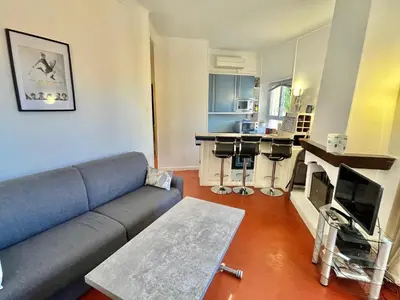 a living room with a couch and a kitchen at Cannes Suquet by Welcome to Cannes in Cannes