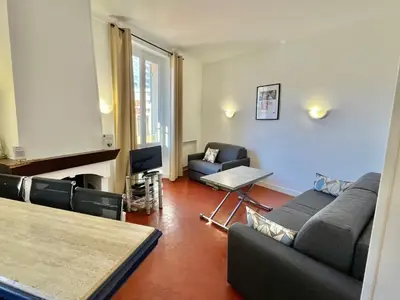 a living room with a couch and chairs and a fireplace at Cannes Suquet by Welcome to Cannes in Cannes