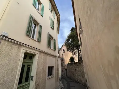 an alley between two buildings with a green door at Cannes Suquet by Welcome to Cannes in Cannes